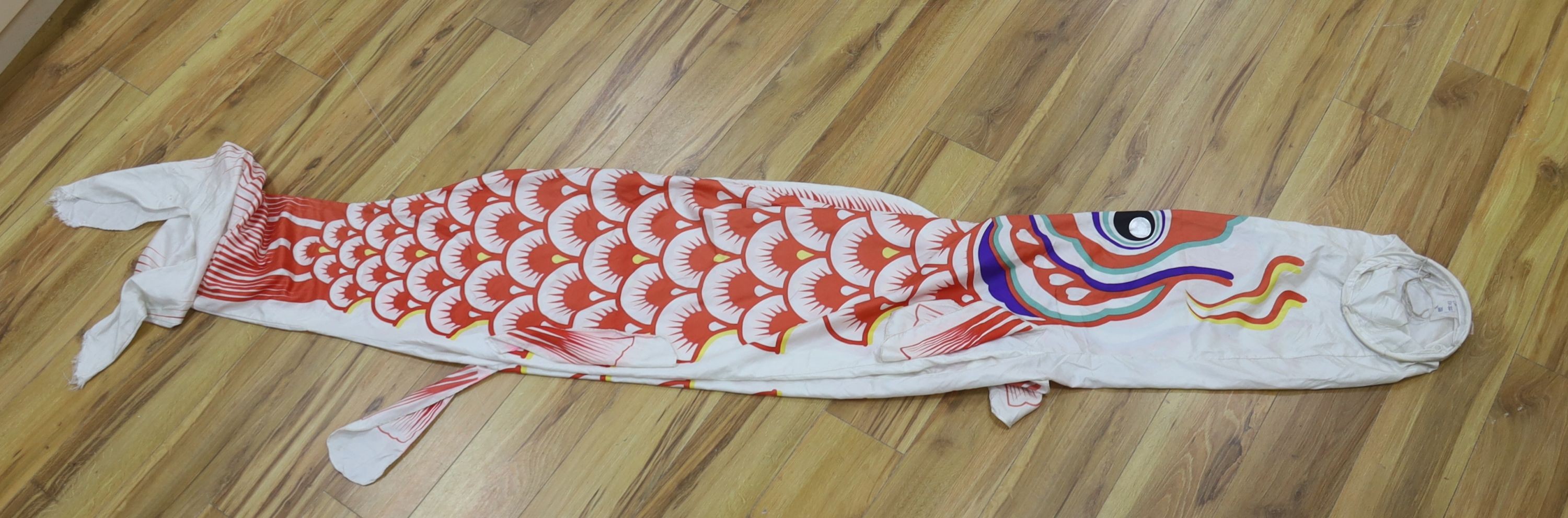 Two Japanese kite flags and various obi's and textiles
